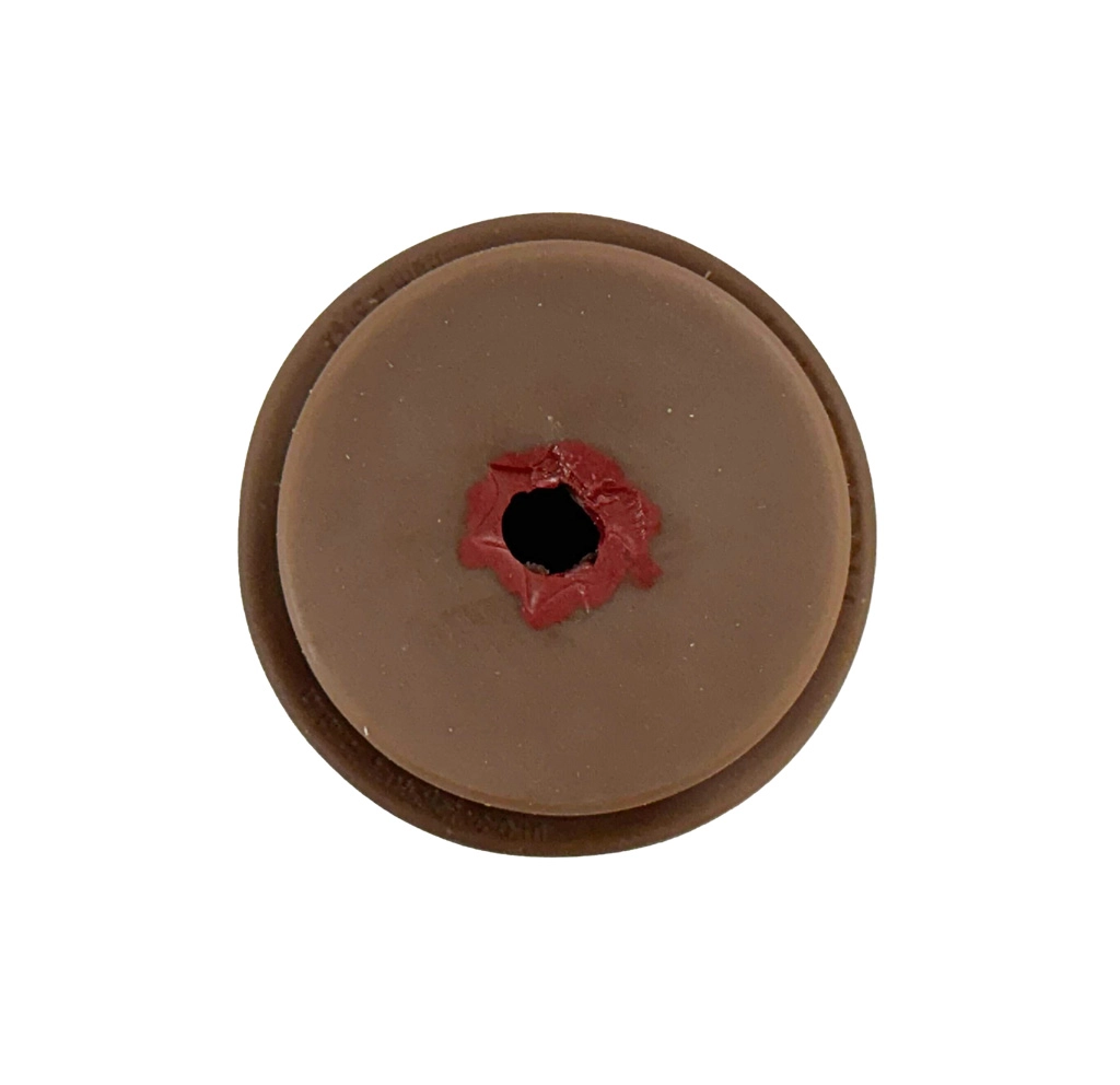Top view of the TrueClot dark skin tone wound packing trainer insert showing a detailed simulated gunshot wound cavity used for haemorrhage control training, wound packing drills, and realistic trauma simulation.
