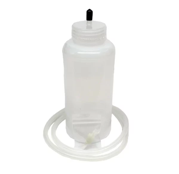 TrueClot training fluid bottle with attached clear tubing for delivering simulated blood in wound packing and trauma training.