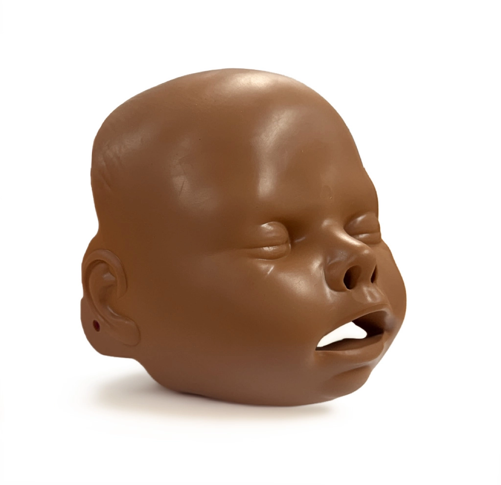 Brown infant CPR training manikin head showing closed eyes, open mouth and nostrils, viewed from a slight side angle on a white background.